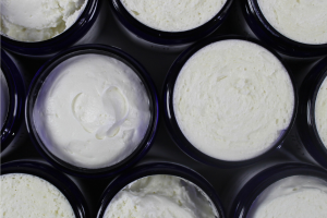 Open containers of Impossibly You whipped body butter