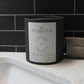 Impossibly you jasmine and green tea bath salts next to a bath room sink and a towel