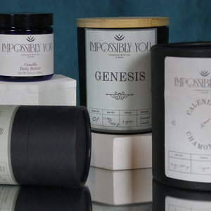 Multiple impossibly you products: genesis scented soy wax candle, calendula and chamomile bath salts, and vanilla scented body butter body butter.