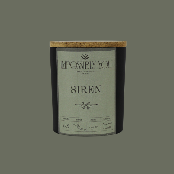 Impossibly you siren scented soy wax candle with a green background