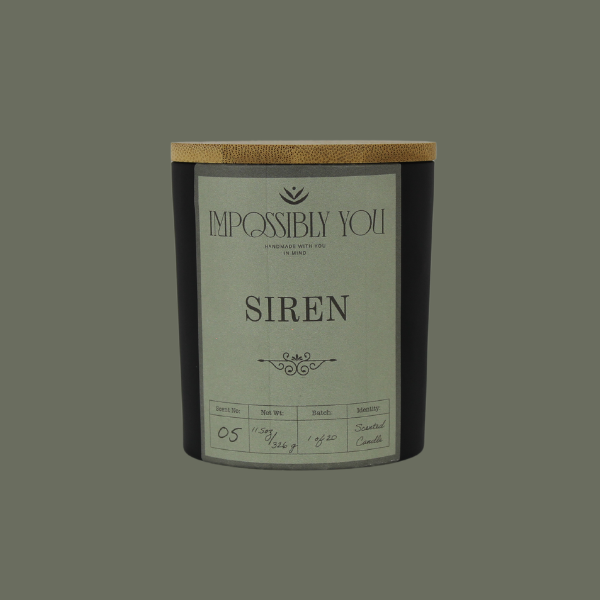 Impossibly you siren scented soy wax candle with a green background