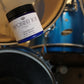 Full size sandalwood scented body butter on a drum set.