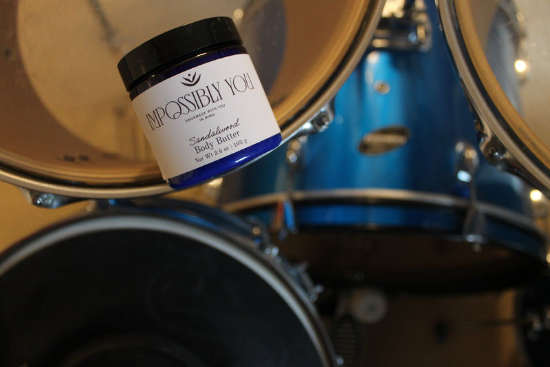 Full size sandalwood scented body butter on a drum set.